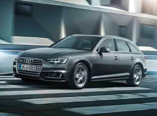 Grauer Audi A4 Kombi fährt auf einer Stadtstraße.