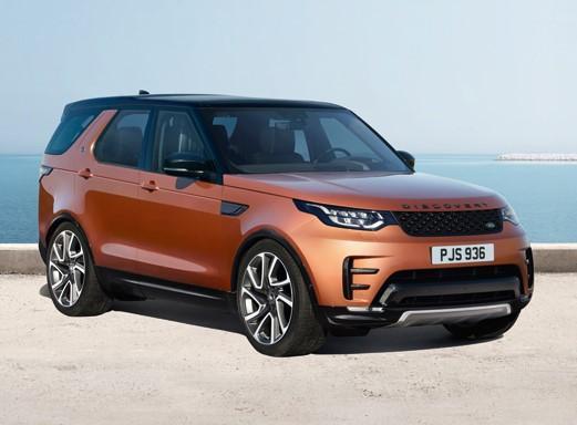 Orange Land Rover Discovery car on asphalt.